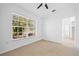 Well-lit bedroom featuring a window and access to other rooms at 28434 Sabal Palm Dr, Punta Gorda, FL 33982