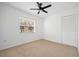 Bright bedroom with neutral carpeting and window at 28434 Sabal Palm Dr, Punta Gorda, FL 33982