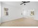 Spacious bedroom with multiple windows and access to another room at 28434 Sabal Palm Dr, Punta Gorda, FL 33982