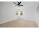 Bright bedroom with ceiling fan and two windows at 28434 Sabal Palm Dr, Punta Gorda, FL 33982