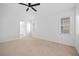 Bright bedroom with ceiling fan and access to bathroom at 28434 Sabal Palm Dr, Punta Gorda, FL 33982