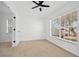 Bright bedroom with ceiling fan and large window at 28434 Sabal Palm Dr, Punta Gorda, FL 33982