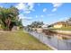 House on a canal with a grassy backyard and dock at 28434 Sabal Palm Dr, Punta Gorda, FL 33982