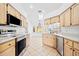 Kitchen with stainless steel appliances and light wood cabinets at 28434 Sabal Palm Dr, Punta Gorda, FL 33982