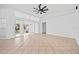 Living room with tile floor, sliding glass doors, and ceiling fan at 28434 Sabal Palm Dr, Punta Gorda, FL 33982