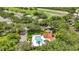Community pool with surrounding lounge chairs and residential buildings at 3112 Club Dr # 124, Port Charlotte, FL 33953