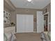 Bright bedroom with twin beds, dresser, and access to a hallway at 3112 Club Dr # 124, Port Charlotte, FL 33953