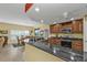 Open kitchen features dark wood cabinets and granite counters at 3112 Club Dr # 124, Port Charlotte, FL 33953