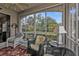 Spacious screened lanai with wicker furniture and serene outdoor views at 3112 Club Dr # 124, Port Charlotte, FL 33953