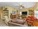 Bright living room with a large TV and comfortable seating at 3112 Club Dr # 124, Port Charlotte, FL 33953