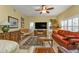 Bright living room with a large TV and comfortable seating at 3112 Club Dr # 124, Port Charlotte, FL 33953