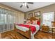 Bright main bedroom with wood flooring and sliding doors at 3112 Club Dr # 124, Port Charlotte, FL 33953