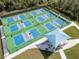 Expansive pickleball courts with a shaded seating area at 3112 Club Dr # 124, Port Charlotte, FL 33953