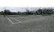 Well-maintained tennis court with seating area at 3112 Club Dr # 124, Port Charlotte, FL 33953