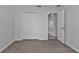 Bedroom with double door closet and wood-look floors at 3175 Eagle Pass St, North Port, FL 34286