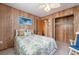 Bedroom with wood paneling, ceiling fan and closet at 3461 Normandy Dr, Port Charlotte, FL 33952