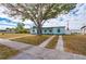 Light blue house with carport and mature tree in front yard at 3461 Normandy Dr, Port Charlotte, FL 33952