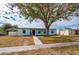 Ranch-style home with walkway and mature tree at 3461 Normandy Dr, Port Charlotte, FL 33952