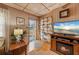 Cozy living room with wood paneling, fireplace, and TV at 3461 Normandy Dr, Port Charlotte, FL 33952