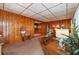 Living room with wood paneled walls and wood floors at 3461 Normandy Dr, Port Charlotte, FL 33952