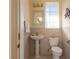 Updated bathroom with pedestal sink, toilet and tiled floor at 358 Paramaribo St, Punta Gorda, FL 33983