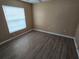 Bright bedroom with wood-look floors and window blinds at 3739 Eldron Ave, North Port, FL 34286