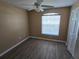 Simple bedroom with wood-look floors and ceiling fan at 3739 Eldron Ave, North Port, FL 34286