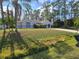 Single-story house with a well-manicured lawn and mature trees at 3739 Eldron Ave, North Port, FL 34286
