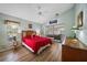 Main bedroom with a red bedspread, wood furniture and access to a patio at 428 Rose Apple Cir, Port Charlotte, FL 33954