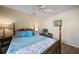 Bedroom with wooden bed frame, ceiling fan, and armchair at 428 Rose Apple Cir, Port Charlotte, FL 33954