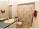 Bathroom with sink, toilet, and floral shower curtain at 4330 Shappell St, Port Charlotte, FL 33948