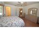 Bedroom with floral bedding, dresser, and view of kitchen at 4330 Shappell St, Port Charlotte, FL 33948