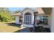 Front entry of a single story house with landscaping and screen door at 4330 Shappell St, Port Charlotte, FL 33948