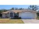 One-story home with attached garage, landscaped lawn, and neutral color scheme at 4330 Shappell St, Port Charlotte, FL 33948