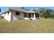 Back exterior view of house with patio and yard at 4330 Shappell St, Port Charlotte, FL 33948