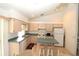Efficient kitchen with white appliances and teal countertops at 4330 Shappell St, Port Charlotte, FL 33948
