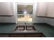 Clean kitchen sink with double basin and window overlooking backyard at 4330 Shappell St, Port Charlotte, FL 33948