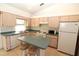 Clean kitchen featuring light wood cabinets and a breakfast bar at 4330 Shappell St, Port Charlotte, FL 33948