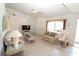 Living room with tiled floors, sofas, and a large TV at 4330 Shappell St, Port Charlotte, FL 33948