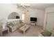 Bright living room with tiled floors, floral sofa, and a view of the backyard at 4330 Shappell St, Port Charlotte, FL 33948