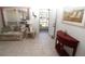 Living room with tiled floors, sofa, and view of front door entry at 4330 Shappell St, Port Charlotte, FL 33948