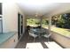 Bright screened porch with seating area and view of backyard at 4330 Shappell St, Port Charlotte, FL 33948