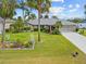 Single story home with nicely landscaped yard and palm trees at 472 Eppinger Dr, Port Charlotte, FL 33953