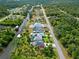 Aerial view of canal-front home with pool and lush landscaping at 472 Eppinger Dr, Port Charlotte, FL 33953