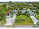 Aerial view of a single-Gathering home with a large yard and detached garage at 472 Eppinger Dr, Port Charlotte, FL 33953
