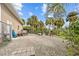 Large gravel backyard with fenced area, storage shed, and tropical plants at 472 Eppinger Dr, Port Charlotte, FL 33953