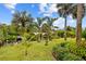 Landscaped backyard with tropical plants and canal views at 472 Eppinger Dr, Port Charlotte, FL 33953