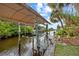 Covered boat lift with adjacent dock and canal views at 472 Eppinger Dr, Port Charlotte, FL 33953