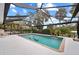 Inviting screened pool area with brick coping and lounge chair at 472 Eppinger Dr, Port Charlotte, FL 33953