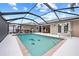 Inviting swimming pool with a screened enclosure and outdoor kitchen at 472 Eppinger Dr, Port Charlotte, FL 33953